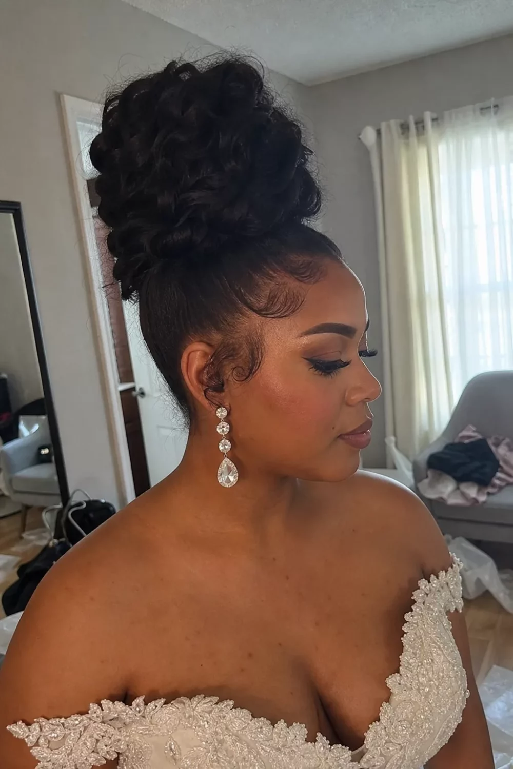 Tall voluminous curly bun, one of the best bridal hair updos for Black women