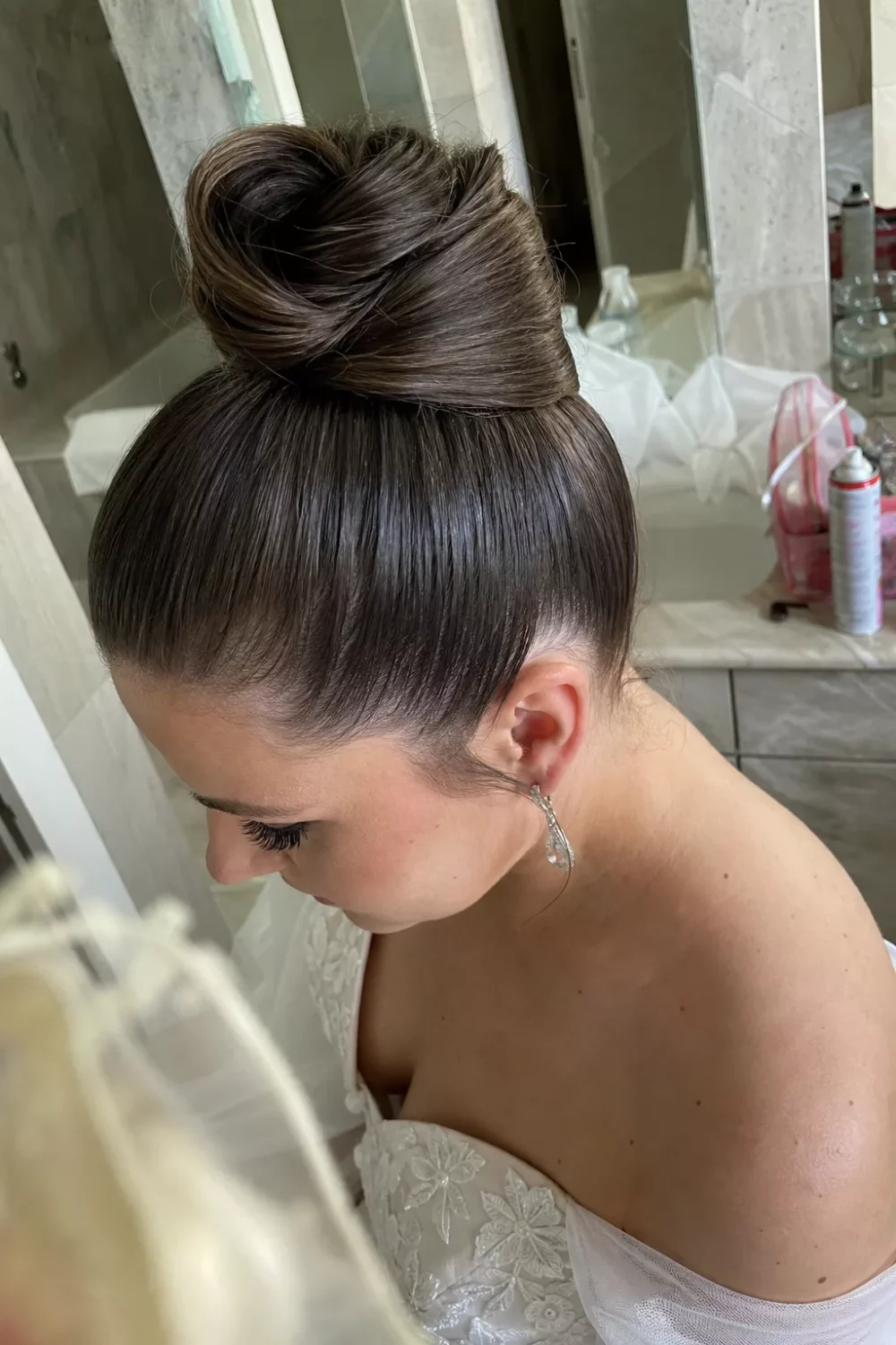 Bride with high twisted ponytail updo, one of many Glam Bridal Hair Updos ideas