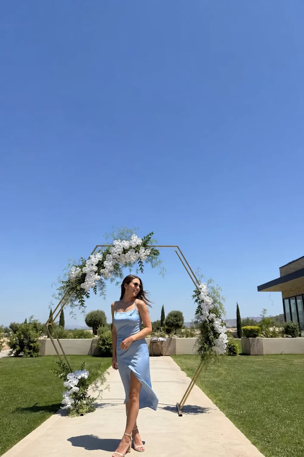 Geometric gold arch with white orchids, a modern take on spring wedding arches